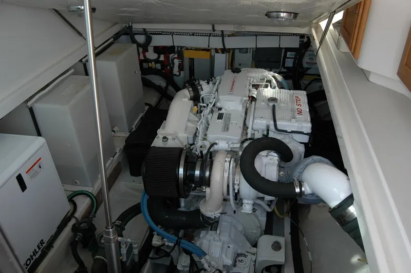 Slide: The Image of Engine room of a 2014 Back Cove 34 boat, featuring a Cummins engine. - 105