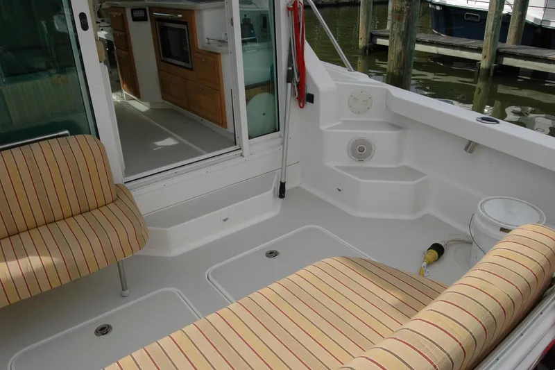 Slide: The Image of 2014 Back Cove 34 boat interior with striped seating and kitchenette. - 27
