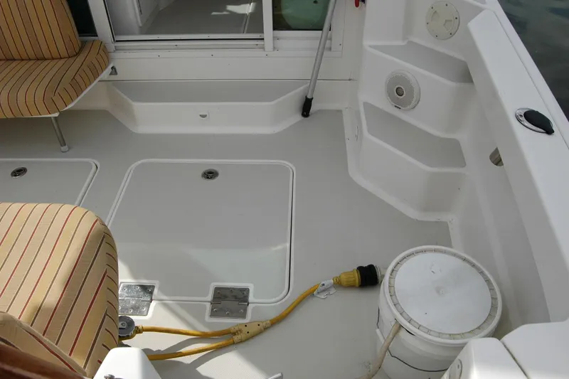 Slide: The Image of 2014 Back Cove 34 boat deck with striped seating and marine equipment. - 28