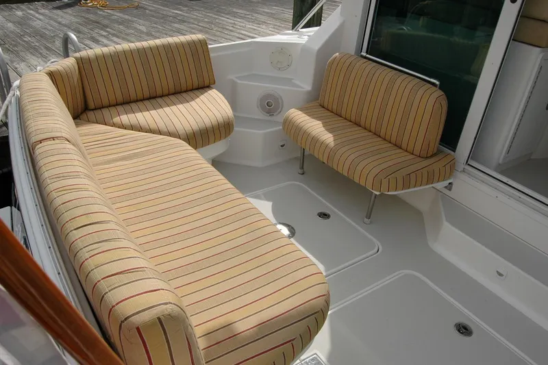Slide: The Image of 2014 Back Cove 34 boat with striped seating in the cockpit area. - 29