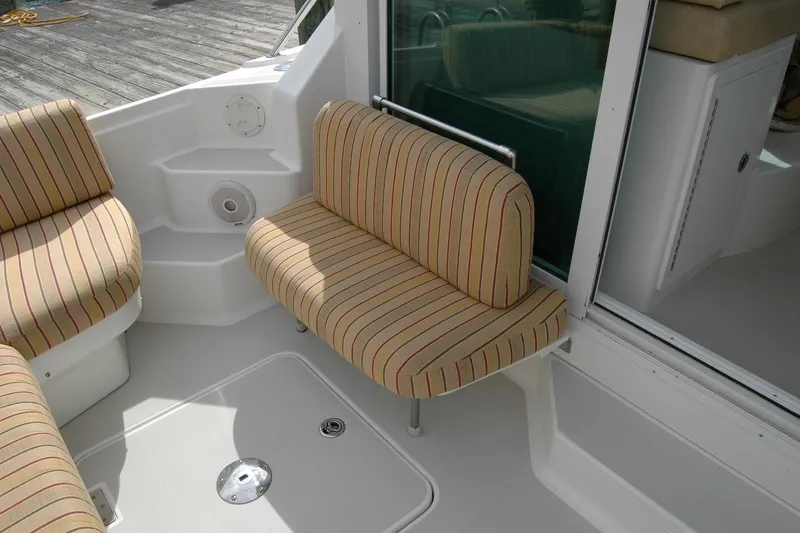 Slide: The Image of 2014 Back Cove 34 boat interior with striped seating and white deck. - 32