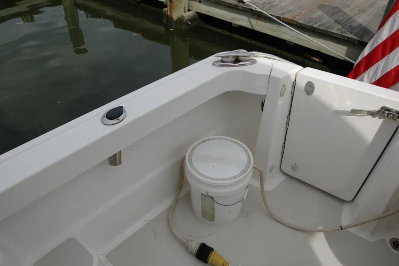 Slide: The Image of 2014 Back Cove 34 boat deck with storage compartment and American flag. - 34