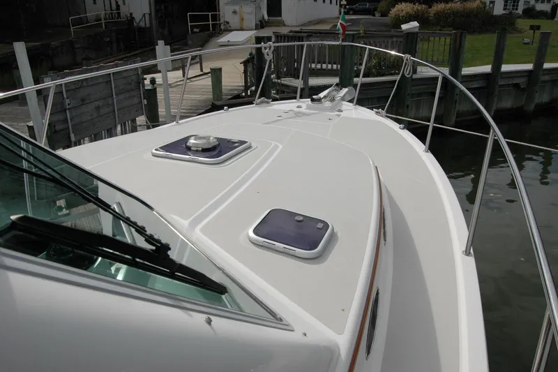 Slide: The Image of 2014 Back Cove 34 boat deck with hatches, docked at marina. - 35