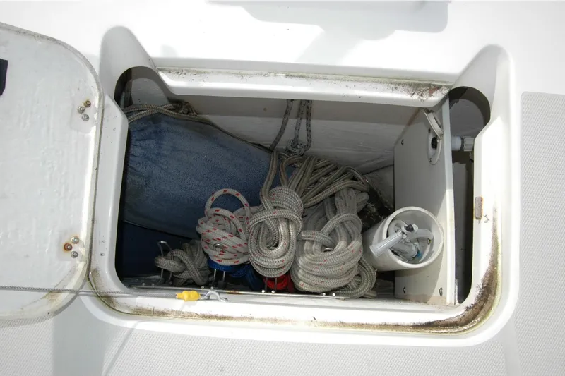Slide: The Image of Storage compartment on a 2014 Back Cove 34 boat with ropes and equipment. - 40