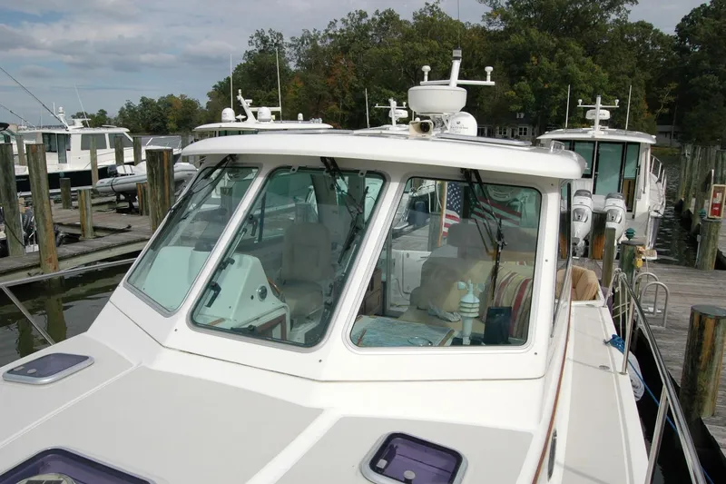 Slide: The Image of 2014 Back Cove 34 boat docked at marina, featuring spacious cabin and modern design. - 44