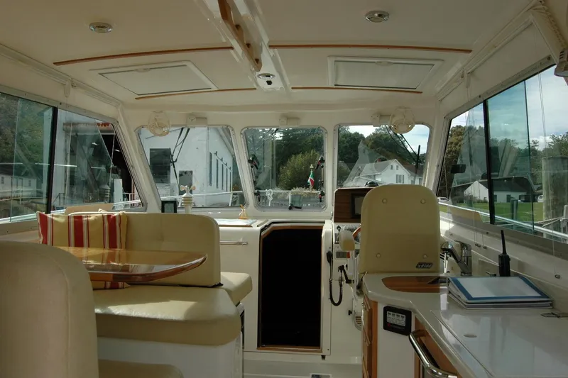 Slide: The Image of Interior of a 2014 Back Cove 34 boat, featuring seating and navigation area. - 47