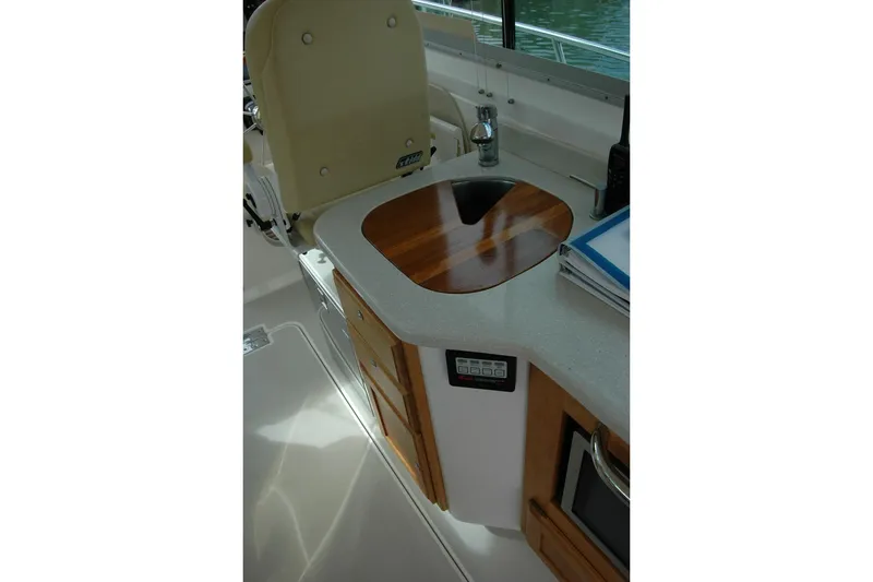 Slide: The Image of 2014 Back Cove 34 boat interior with sink, countertop, and storage cabinets. - 52