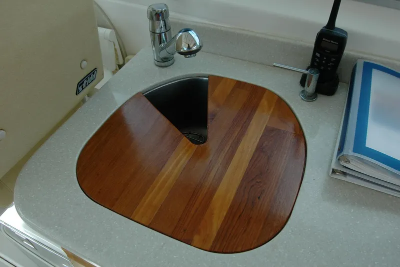 Slide: The Image of 2014 Back Cove 34 yacht sink with wooden cover and faucet. - 54