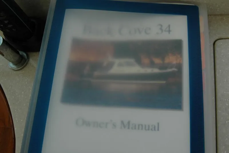 Slide: The Image of Owner's manual for 2014 Back Cove 34 boat, featuring cover image of the vessel. - 55