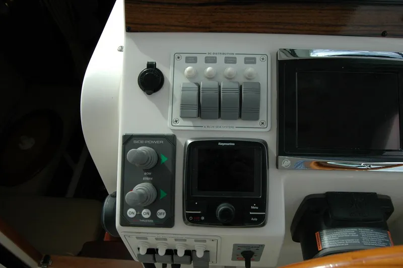 Slide: The Image of Control panel of a 2014 Back Cove 34 boat with navigation and power switches. - 58