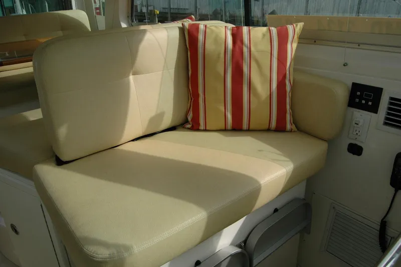 Slide: The Image of Cozy seating area on 2014 Back Cove 34 boat with striped cushion. - 63