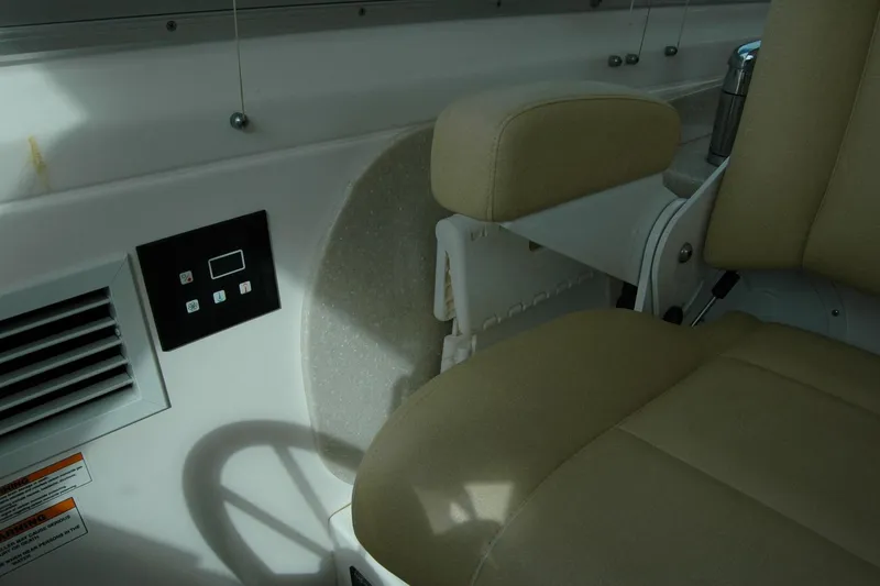 Slide: The Image of Interior of 2014 Back Cove 34 boat showing control panel and beige seating. - 66