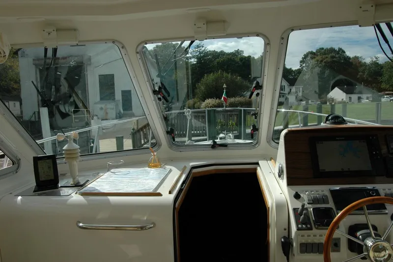 Slide: The Image of 2014 Back Cove 34 yacht helm with navigation equipment and scenic marina view. - 69