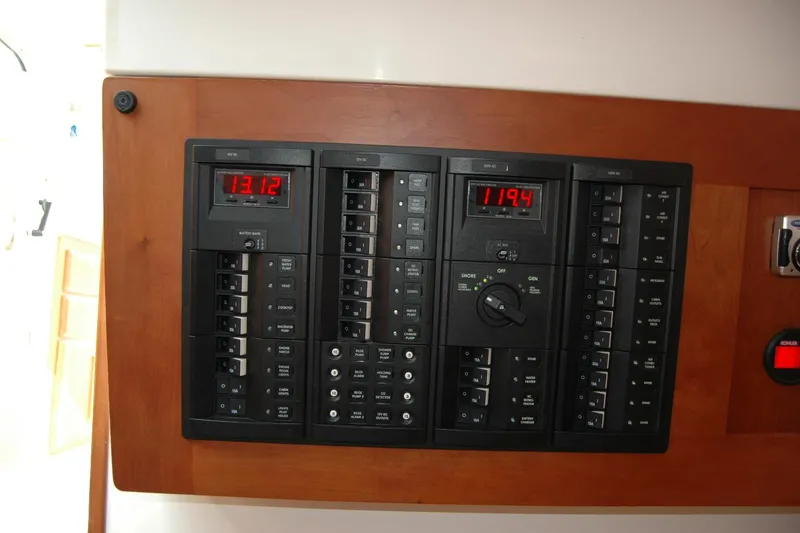 Slide: The Image of Electrical panel of a 2014 Back Cove 34 boat, featuring digital displays and switches. - 72