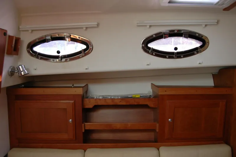 Slide: The Image of Interior of 2014 Back Cove 34 boat with wooden cabinets and oval windows. - 75