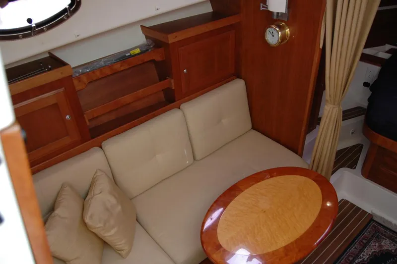 Slide: The Image of Interior of 2014 Back Cove 34 yacht with beige sofa and wooden table. - 77