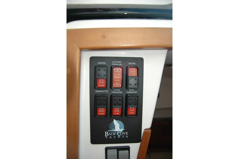 Slide: The Image of Control panel of 2014 Back Cove 34 yacht with labeled switches. - 80