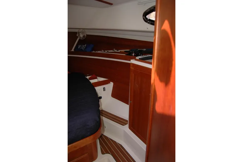Slide: The Image of 2014 Back Cove 34 cabin interior with wood finish and bed. - 83