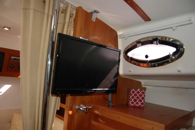 Slide: The Image of Interior of 2014 Back Cove 34 boat with TV and porthole window. - 87