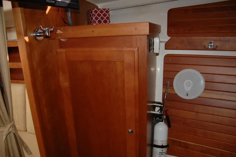 Slide: The Image of Interior of 2014 Back Cove 34 boat with wooden cabinetry and safety equipment. - 88