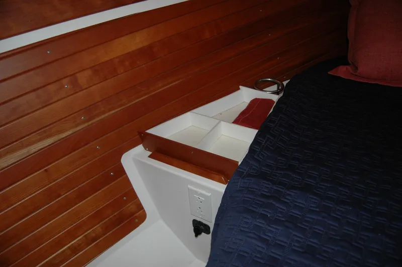 Slide: The Image of Interior of 2014 Back Cove 34 boat with wooden paneling and storage compartment. - 90