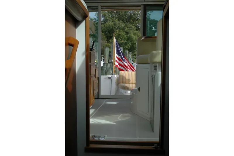 Slide: The Image of Interior view of 2014 Back Cove 34 boat with American flag visible through doorway. - 92