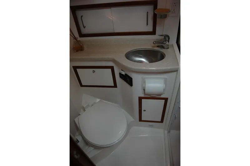 Slide: The Image of 2014 Back Cove 34 yacht bathroom with sink, toilet, and storage cabinets. - 97