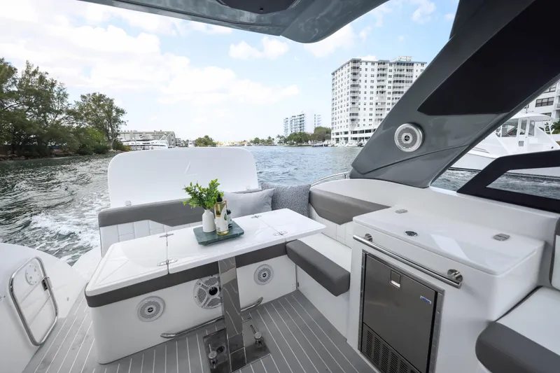 Slide: The Image of Luxury Valiatt 350GT yacht interior with modern seating, table, and scenic waterfront view. - 8