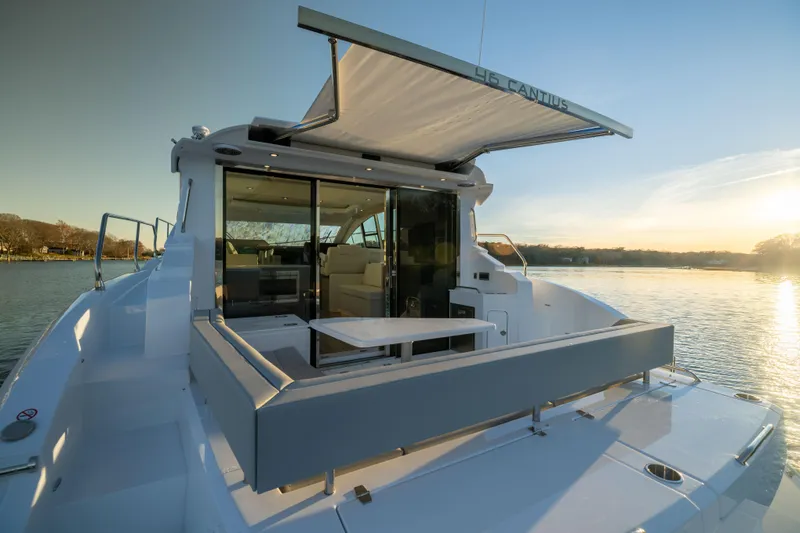 Slide: The Image of 2026 Cruisers Yachts 46 Cantius, luxury yacht with open deck, sunset view. - 10