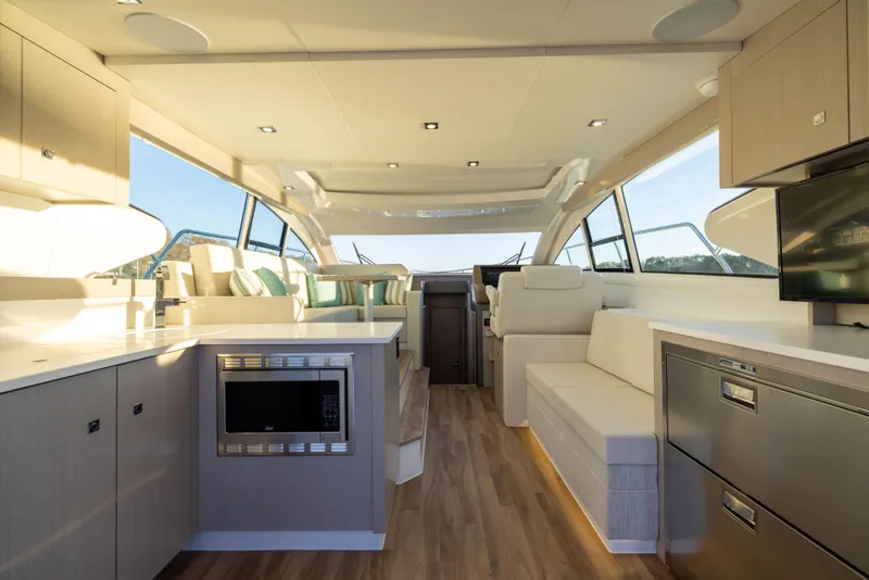 Slide: The Image of Luxurious interior of 2026 Cruisers Yachts 46 Cantius with modern kitchen and seating area. - 17