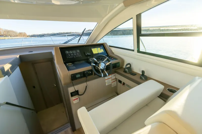 Slide: The Image of Interior helm of 2026 Cruisers Yachts 46 Cantius with modern controls and scenic view. - 25