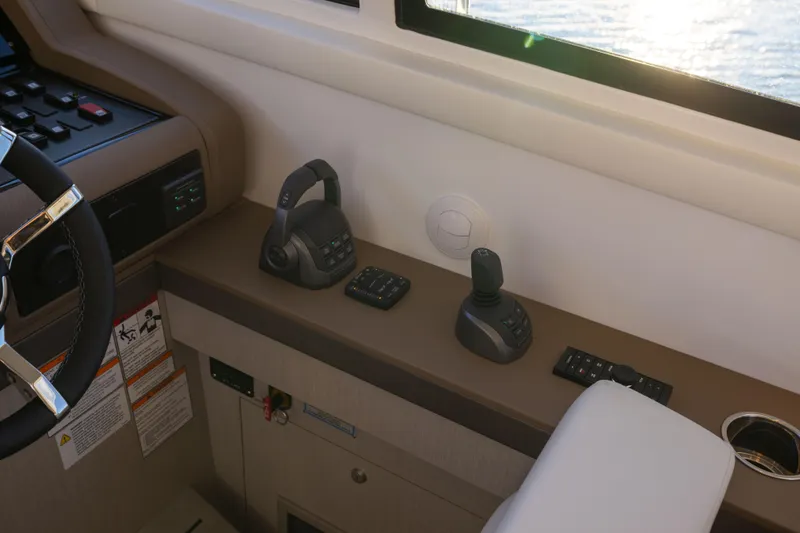 Slide: The Image of Helm controls of 2026 Cruisers Yachts 46 Cantius with steering wheel and joystick. - 27