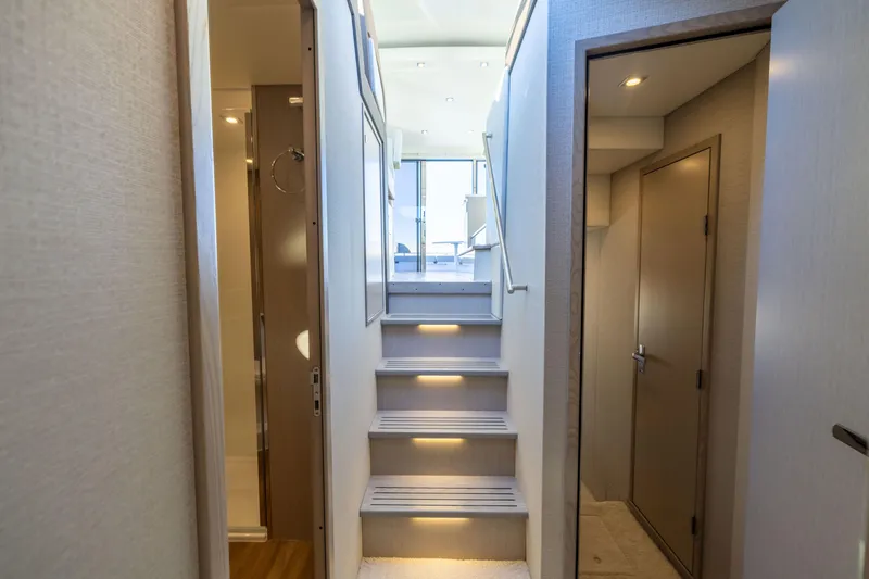 Slide: The Image of Interior view of 2026 Cruisers Yachts 46 Cantius, featuring illuminated stairs and modern design. - 47