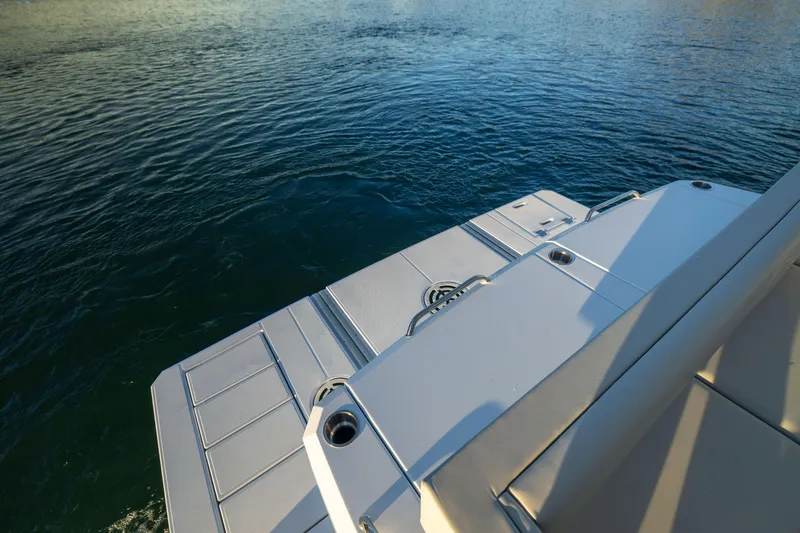 Slide: The Image of 2026 Cruisers Yachts 46 Cantius swim platform on calm water. - 51