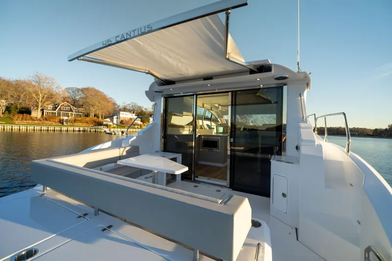 Slide: The Image of 2026 Cruisers Yachts 46 Cantius, luxury yacht with open deck and scenic waterfront view. - 9
