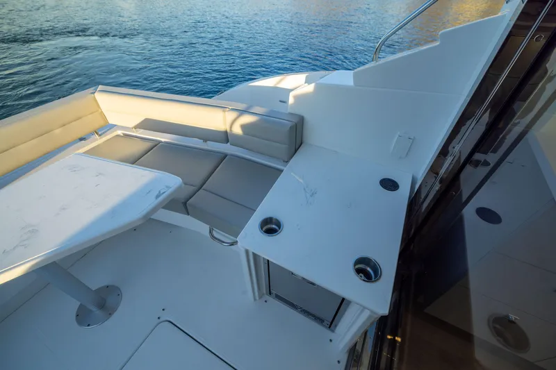 Slide: The Image of Luxury seating area on 2026 Cruisers Yachts 46 Cantius, overlooking serene water. - 14