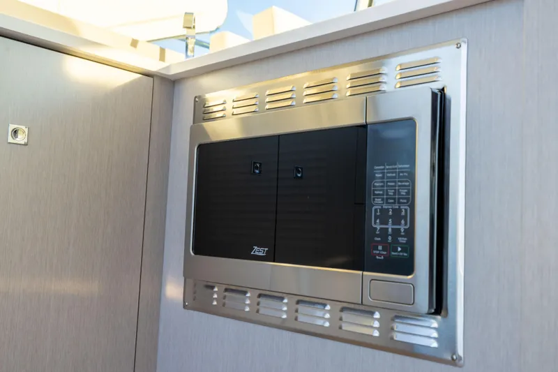 Slide: The Image of Built-in microwave in 2026 Cruisers Yachts 46 Cantius, featuring sleek stainless steel design. - 22
