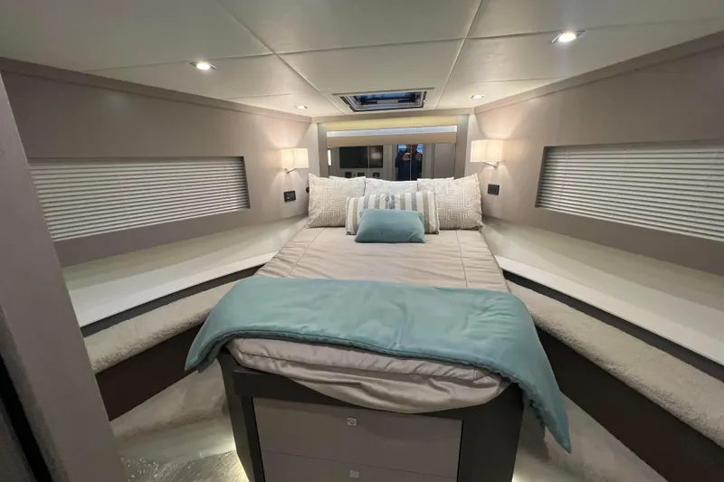 Slide: The Image of 2026 Cruisers Yachts 46 Cantius on serene water near waterfront homes. - 4