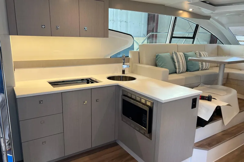 Slide: The Image of 2026 Cruisers Yachts 46 Cantius on serene water with scenic shoreline backdrop. - 5