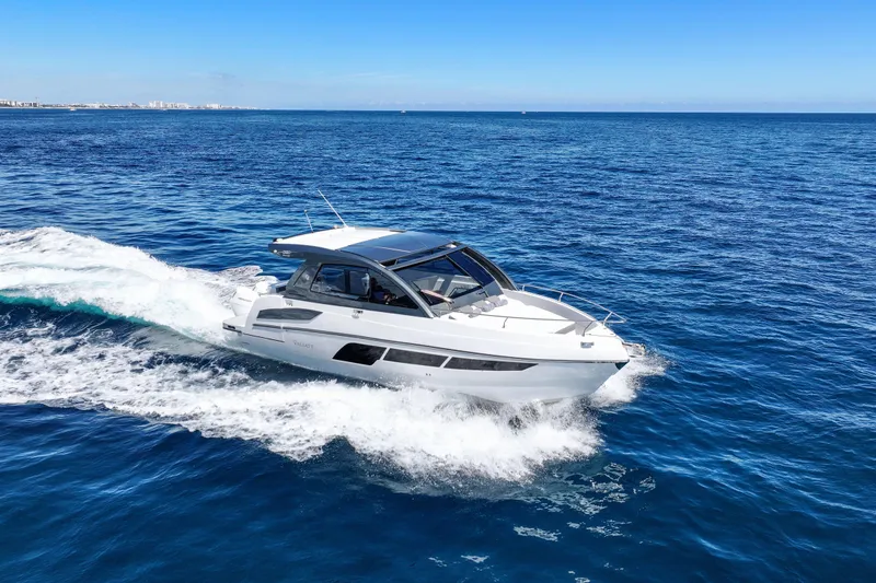Slide: The Image of 2025 VALIATT YACHTS 380 Bowrider cruising on open blue sea under clear sky. - 23
