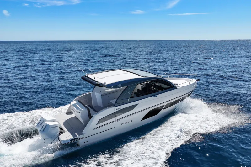 Slide: The Image of 2025 VALIATT YACHTS 380 Bowrider cruising on open sea under clear blue sky. - 24
