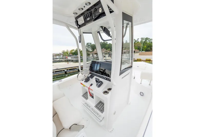 Slide: The Image of 2026 Sea Hunt Ultra 245 SE boat interior with helm and seating area. - 13