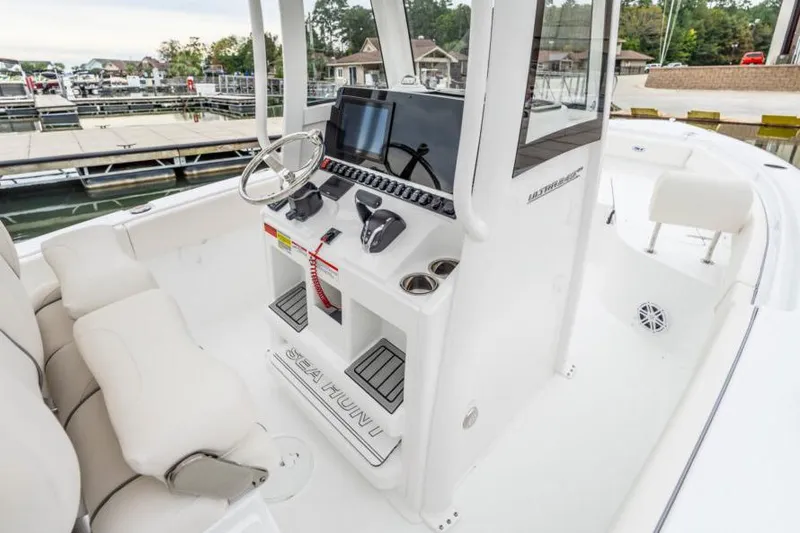 Slide: The Image of 2026 Sea Hunt Ultra 245 SE boat interior seating and storage compartment. - 14
