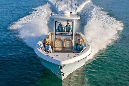 Slide: The Image of Manufacturer Provided Image: 2025 Everglades 285 Center Console boat cruising on clear blue water. - 2