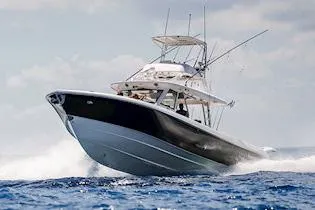 The Image of 2026 Everglades 455 Center Console boat cruising on a scenic lake. - 0