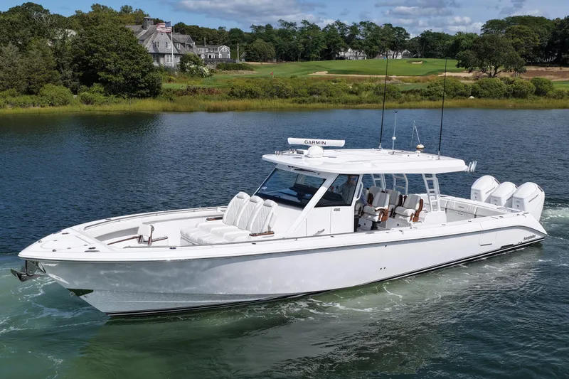 The Image of 2026 Everglades 455 Center Console boat cruising on a scenic lake. - 0