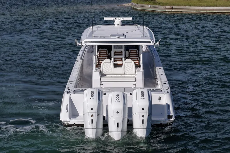 Slide: The Image of 2026 Everglades 455 Center Console boat with triple 600 V12 engines on water. - 12
