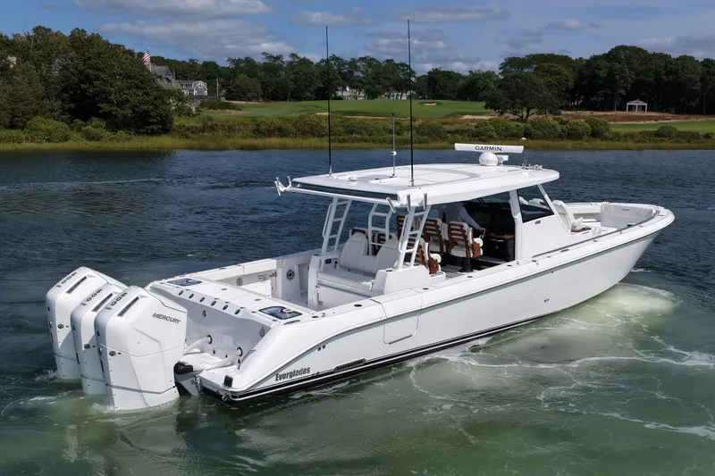 Slide: The Image of 2026 Everglades 455 Center Console boat cruising on a scenic waterway. - 6