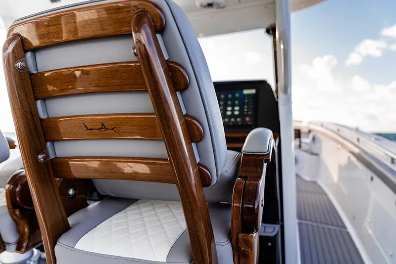 Slide: The Image of 2026 Everglades 455 Center Console boat with triple engines on a scenic waterway. - 7