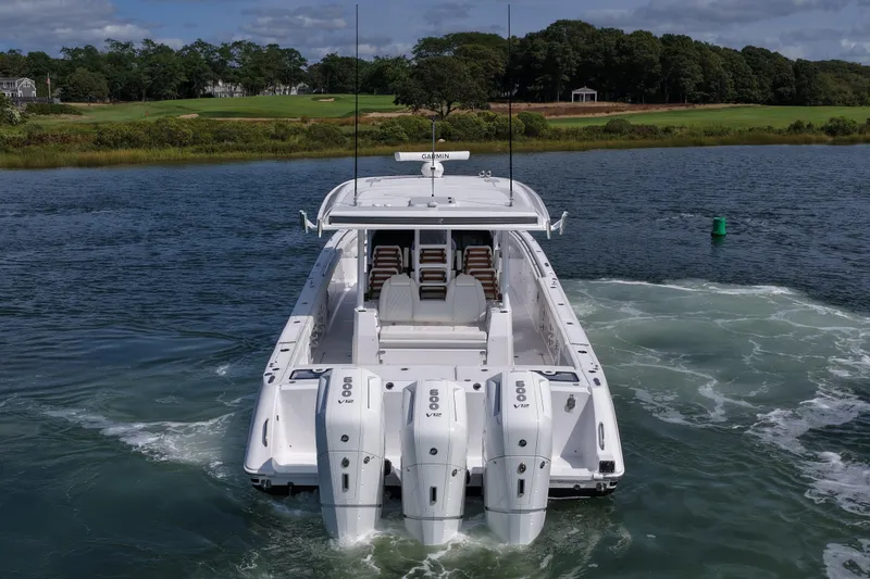 Slide: The Image of 2026 Everglades 455 Center Console boat with triple engines on a scenic waterway. - 8